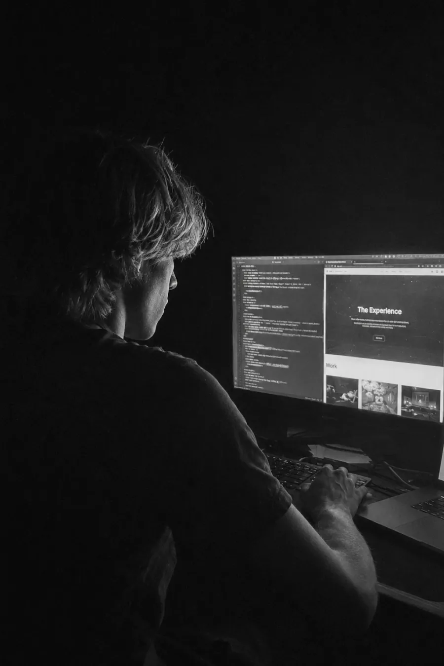 Leander building at his desk at night, lit only by the monitor